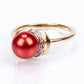 Anillo de Plata Bañada en Oro con Perla roja de río y Topacio Blanco