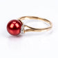 Anillo de Plata Bañada en Oro con Perla roja de río y Topacio Blanco