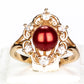 Anillo de Plata Bañada en Oro con Perla roja de río y Topacio Blanco