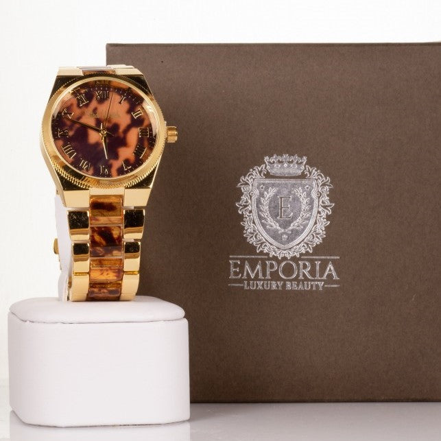 Reloj de aleación para mujer en color dorado con rayas de tigre y esfera con números romanos 2 